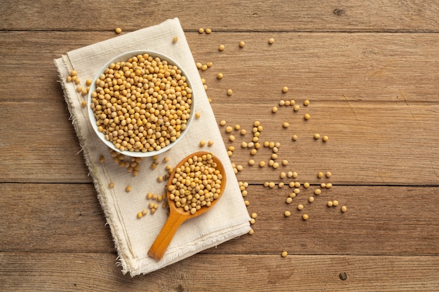 Free photo soybean seeds on wooden floor and hemp sacks food nutrition concept.