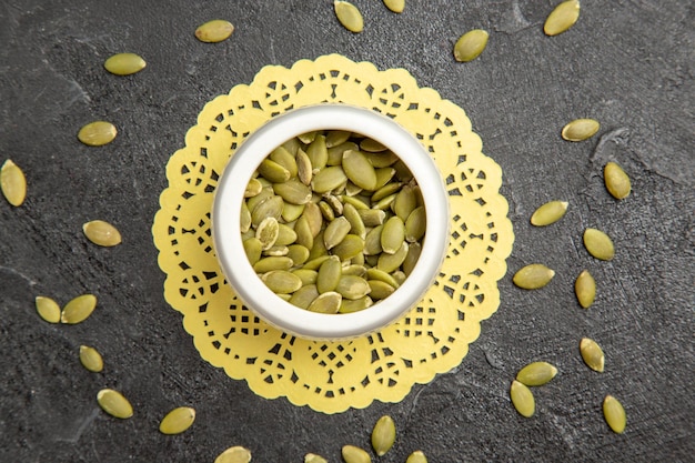 Top view fresh pumpkin seeds on a dark background seed color many pumpkin granule
